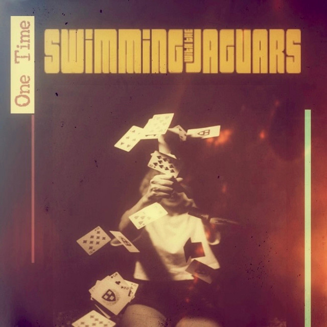 The One Time cover: playing cards flung into the air under the band wordmark, in faded amber light.